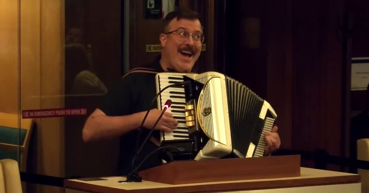 A picture of me, Peter Waldkirch, playing the accordion and singing at the speaker's podium at Vancouver City Council.